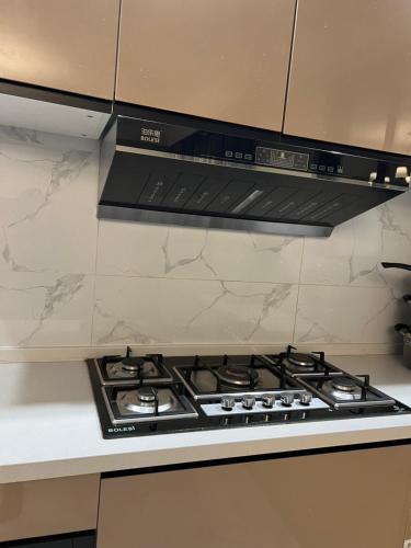 a kitchen with a black stove top oven at Caster two bedrooms apartment jkia in Nairobi