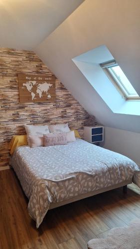 una camera da letto con un letto con una parete in legno di Chambre près du circuit des 24h a Cérans-Foulletourte