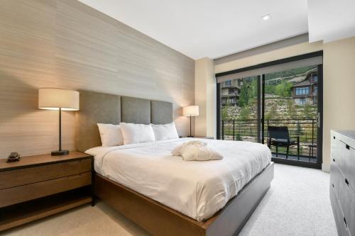a bedroom with a large bed and a large window at Lift Park City Condominiums in Park City