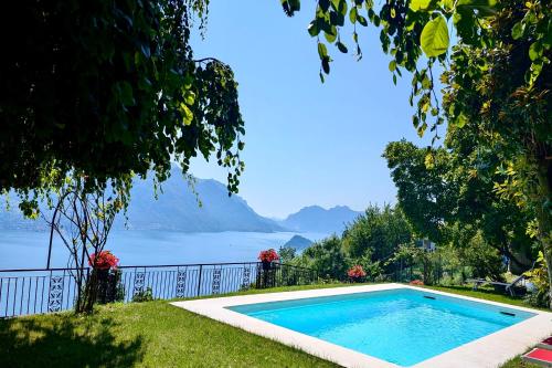 a swimming pool with a view of the water at Chalet Miralago in Plesio