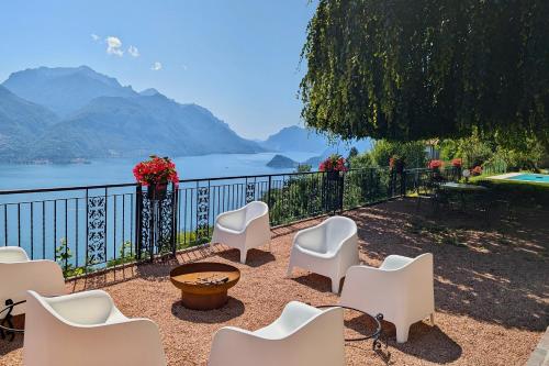 a patio with chairs and a view of the water at Chalet Miralago in Plesio