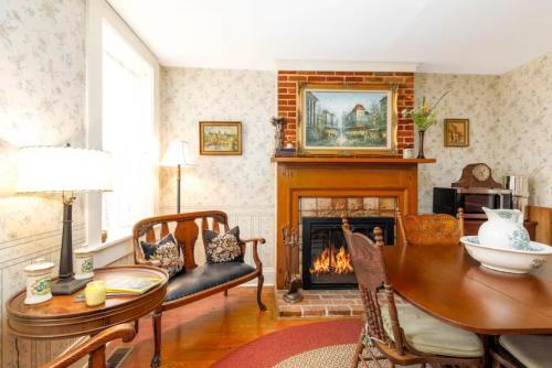 a living room with a table and a fireplace at Briarstone Inn Unit 6 in Galena