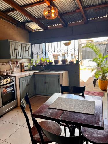 a kitchen with a table and chairs in a room at Casa Colonial in León