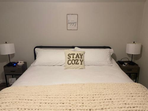 a bedroom with a bed with astay cough pillow on it at Bernice Mae's Ocean View in Lewisporte