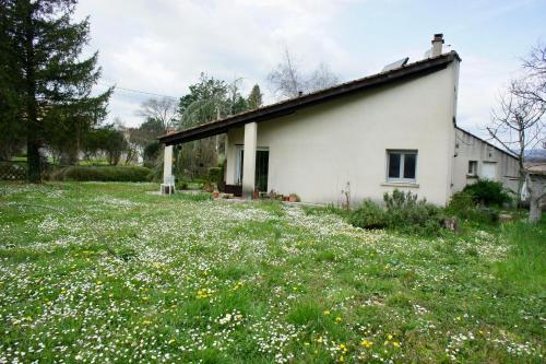 a white house with a field of flowers at Melograni in Chomérac