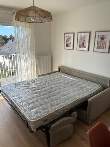 a bed in a room with a couch and a window at Casa Alma in Camiers