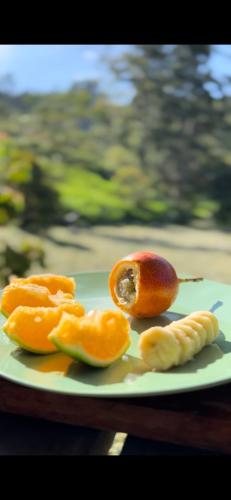 a plate of fruit and a peach and a banana at Taikú Ecolodge in Pacho