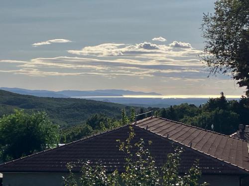 a view of the ocean from the roof of a house at GiuMa Tuscany Historic Country House with Roof Terrace near Saturnia Spa in Montemerano