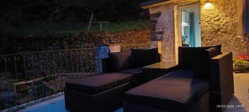 a patio with couches and a window at night at La quiete accesa in Vernazza
