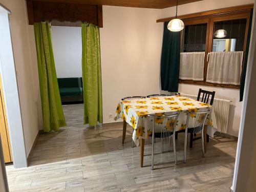 a dining room with a table with a yellow and white table cloth at KARL Apartment in Interlaken