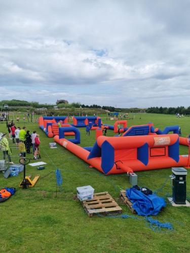 a group of people playing in an inflatable playground at Jay 35 4 bed sleeps up to 8 dog friendly caravan Thornwickbay haven site on East coast in Flamborough