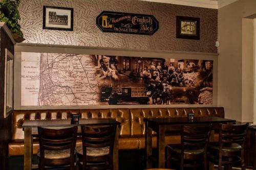 a restaurant with two tables and a map on the wall at Bloomfield Brewhouse in Blackpool