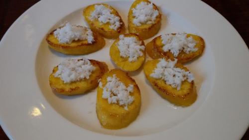 a white plate with twelve pieces of food on it at Mistletoe Homestay & Cafe in Munnar