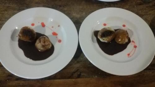 two white plates with food on them on a table at Mistletoe Homestay & Cafe in Munnar