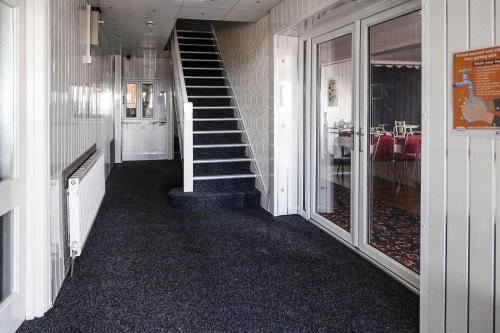 a hallway with a staircase in a building at Harlands Hotel in Blackpool