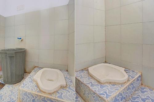 a bathroom with two toilets and a trash can at Hotel O Badar Guest House Syariah in Bandar Lampung