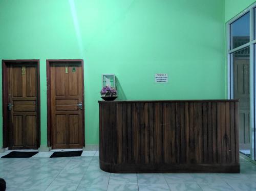a room with two wooden doors and a wooden podium at Hotel O Penginapan Syariah Al Syifa in Kendari