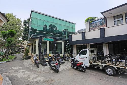 a group of motorcycles parked in front of a building at Hotel O Tjokro 3 in Bogor