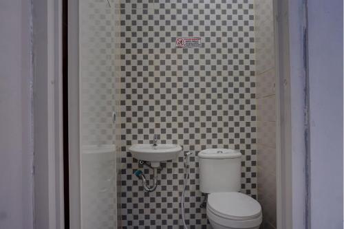 a bathroom with a toilet and a sink at Capital O 92765 J&b Smart Sentul in Bogor