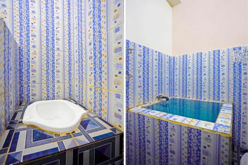 a bathroom with a toilet and a tub at Hotel O Homestay Barokah in Gresik