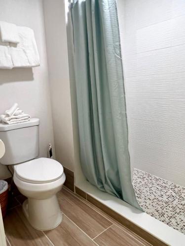 a bathroom with a toilet and a shower at Condo close to Epic Universe - free parking in Orlando