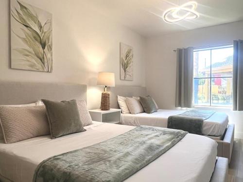 a bedroom with two beds and a window at Condo close to Epic Universe - free parking in Orlando
