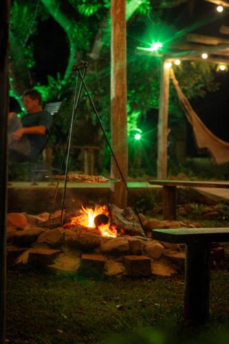 a fire pit in a park at night at Figueira do Rio do Boi Com Hidromassagem in Praia Grande