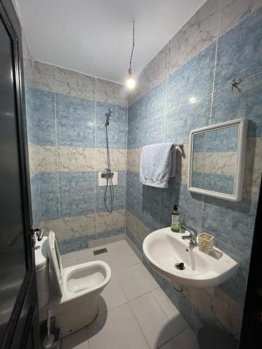 a bathroom with a toilet and a sink at Sabah Appartment in Essaouira