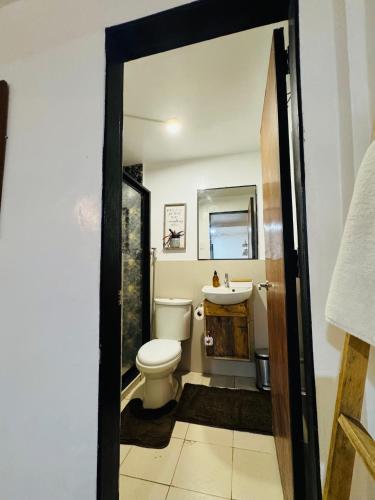 a bathroom with a toilet and a sink at E-Place Resort in Magallanes