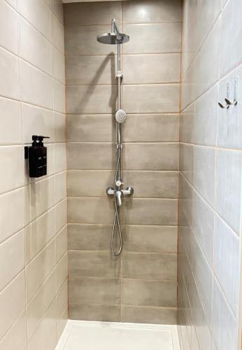 a shower with a shower head in a bathroom at Square house in Funchal