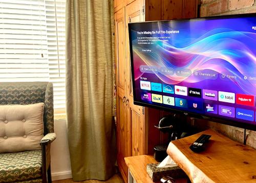 a flat screen tv sitting on top of a table at East Cliff Folkestone Guest Suite With Own Entrance in Folkestone