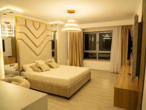 a bedroom with a bed and a living room at Appartement Haut Standing Mobilart Oran in Oran