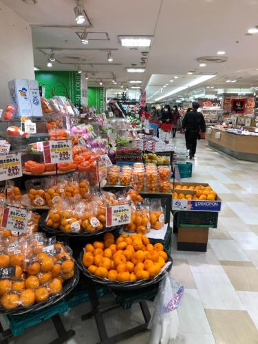 a grocery store filled with oranges and other fruits and vegetables at リブシティ錦糸町参番館上層階眺望良好北欧ルーム, Akihabara 6mins, Tokyo 8 mins, Direct to Narita Airport 成田空港直達 in Tokyo