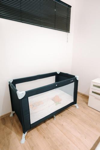 a black bunk bed in a room with a window at Grand appartement rez de jardin in Guebwiller