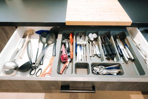 a drawer filled with lots of utensils at Grand appartement rez de jardin in Guebwiller