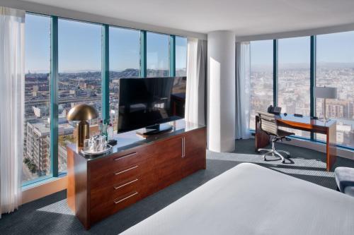 a hotel room with a bed and a desk with a television at InterContinental San Francisco by IHG in San Francisco