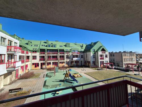 a view of an apartment complex with a playground at Serce Suwałk in Suwałki