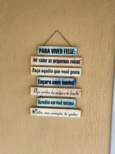 a sign on a wall with different signs on it at Casa Canto do Mar in Maragogi
