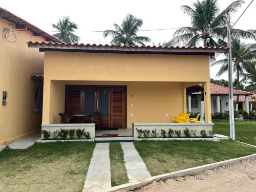 a view of a house with a yard at Casa Canto do Mar in Maragogi