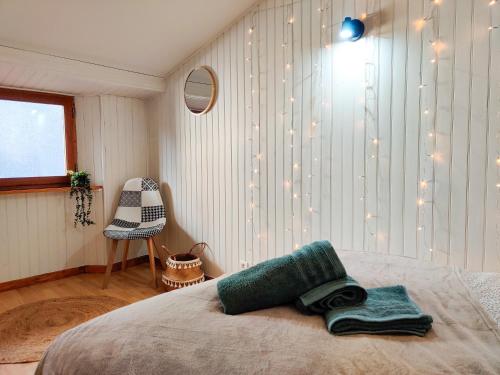 a bedroom with a bed and a window and a chair at Le Refuge du Château in Foix