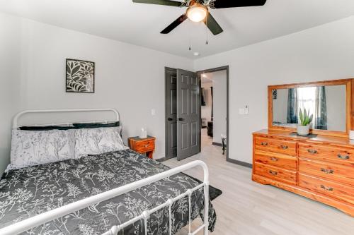 a bedroom with a bed and a dresser and a ceiling fan at Kentucky Lake Retreat 4 Mi to Shore Boat and Fish! in New Johnsonville