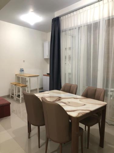 jadalnia z drewnianym stołem i krzesłami w obiekcie House of Luna Peaceful Villa Tengah Kota Pekanbaru w mieście Pekanbaru