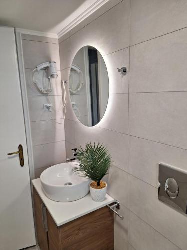 a bathroom with a sink and a mirror at Militsa House in Gaios