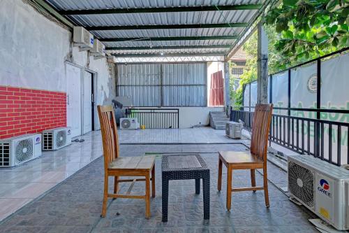 a patio with two chairs and a table on a balcony at OYO Life 92877 Hotel Rainbow 7296 in Semarang