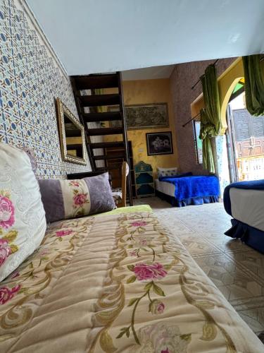 a bedroom with a large bed with flowers on it at RIAD ESMERALDA By Dar Ouezzani in Rabat