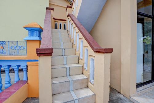 a staircase in a house with a window at OYO 92903 Barokah Hotel Syariah in Sangkapura