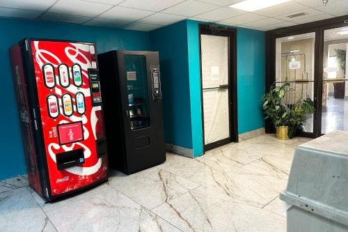 two soda machines in a room with a wall at OYO Hotel Rome West GA in Rome