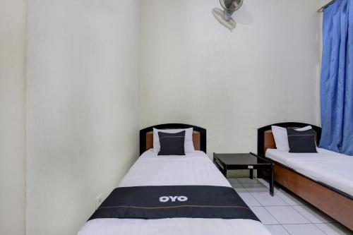 Postel nebo postele na pokoji v ubytování Capital O 93024 Hotel Ganesha