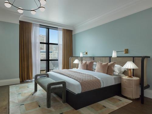 a bedroom with a large bed and a large window at Citizen House Hotel in Oklahoma City