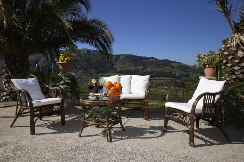 a group of chairs and a table with fruit on it at Casa Luce in Caltabellotta
